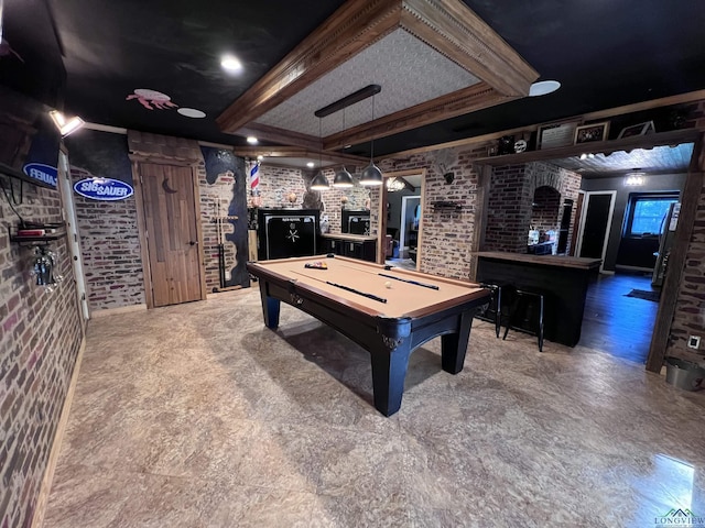 rec room with pool table, beam ceiling, brick wall, and bar area