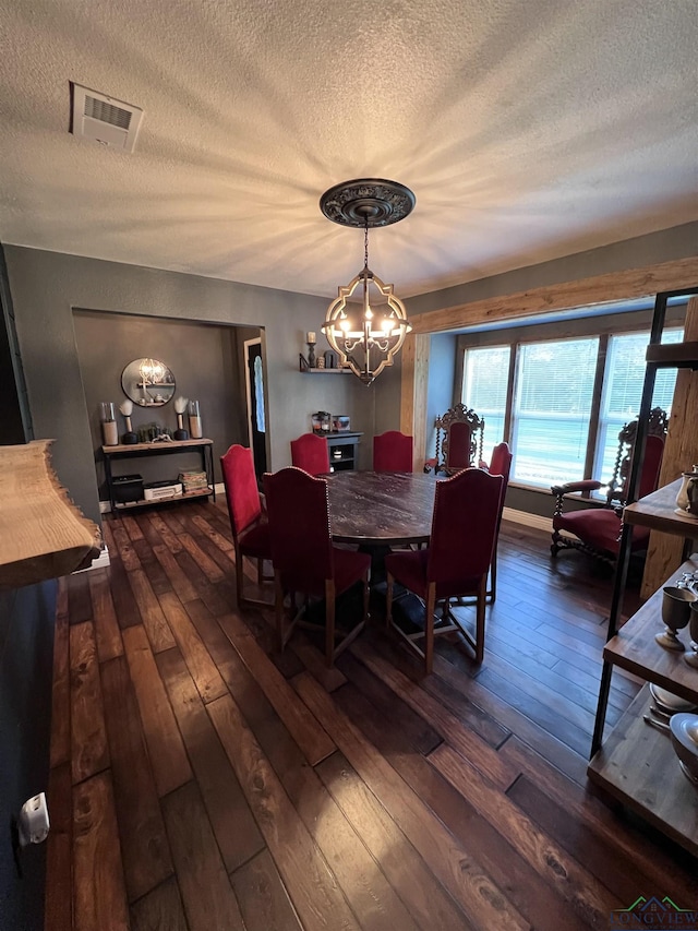 dining area with dark hardwood / wood-style flooring and a notable chandelier