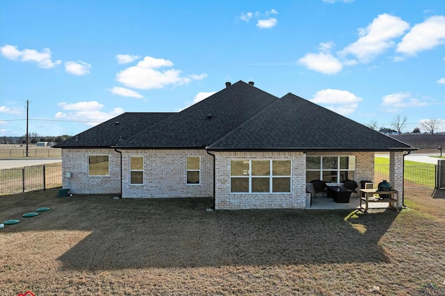 rear view of property featuring a yard and a patio