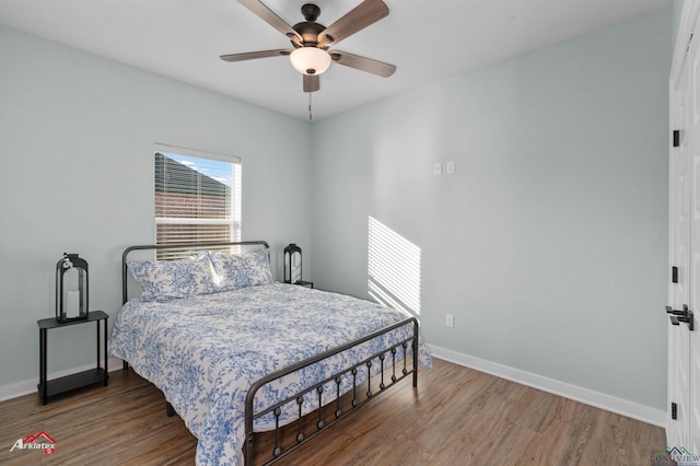 bedroom featuring dark hardwood / wood-style flooring and ceiling fan