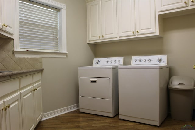 clothes washing area featuring dark hardwood / wood-style floors, cabinets, and separate washer and dryer