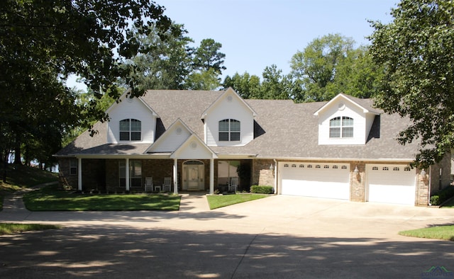 view of front of house featuring a garage and a front lawn