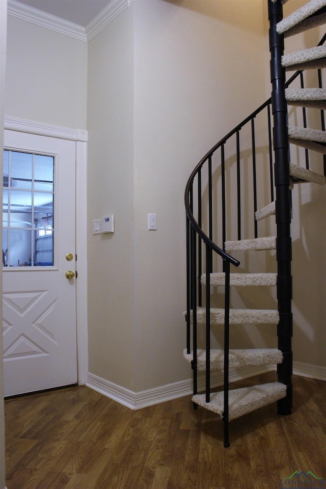 foyer with dark hardwood / wood-style floors and crown molding