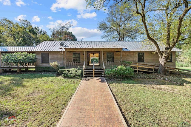 single story home with covered porch and a front yard