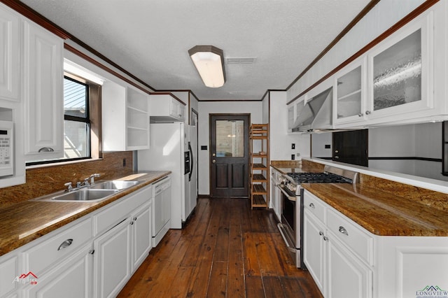 kitchen with sink, dark hardwood / wood-style floors, a textured ceiling, white appliances, and white cabinets