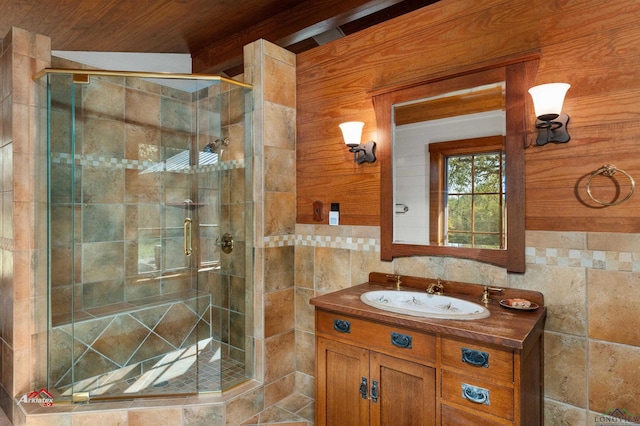 bathroom with wood ceiling, vanity, a shower with door, tile walls, and wood walls