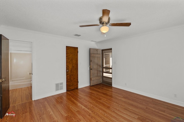 unfurnished bedroom with hardwood / wood-style floors, ceiling fan, crown molding, and a textured ceiling