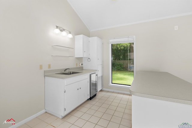 3408 Airline Rd, Longview, TX 75605 - kitchen with crown molding, light countertops, white cabinets, and light tile patterned floors