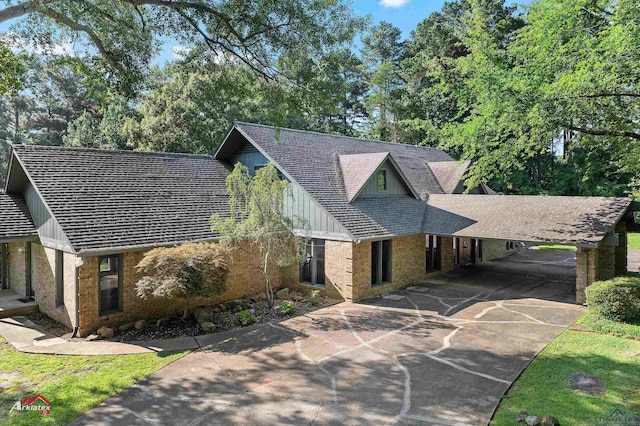 3408 Airline Rd, Longview, TX 75605 - view of front of house featuring driveway, view of wooded area, and board and batten siding