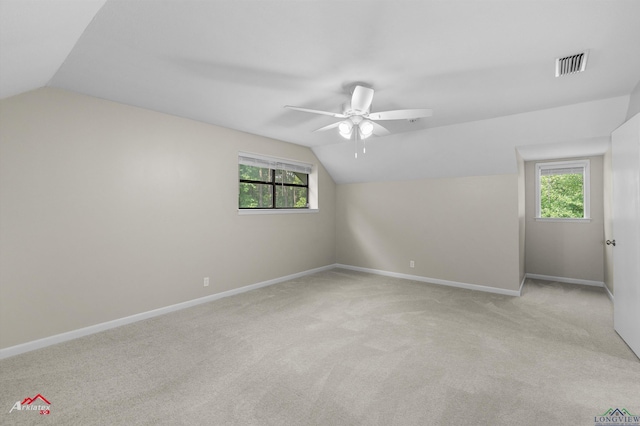 3408 Airline Rd, Longview, TX 75605 - additional living space featuring vaulted ceiling, a ceiling fan, light colored carpet, and healthy amount of natural light