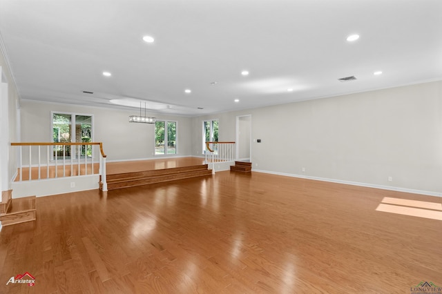 3408 Airline Rd, Longview, TX 75605 - unfurnished living room featuring recessed lighting, crown molding, and light wood-style flooring