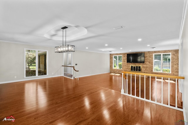 3408 Airline Rd, Longview, TX 75605 - unfurnished living room with healthy amount of natural light, wood finished floors, recessed lighting, and a brick fireplace