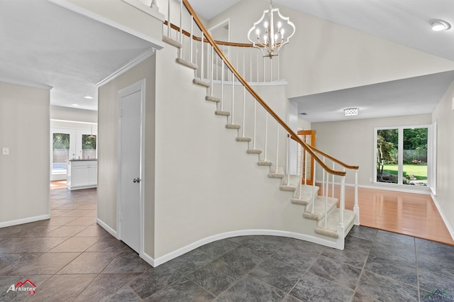 3408 Airline Rd, Longview, TX 75605 - staircase featuring crown molding, stone tile floors, and a chandelier