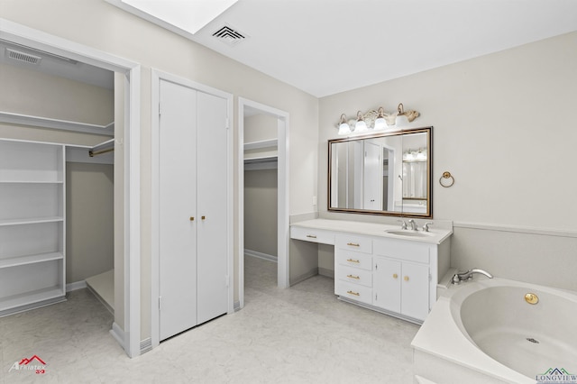 3408 Airline Rd, Longview, TX 75605 - full bathroom with vanity, a bath, and a spacious closet
