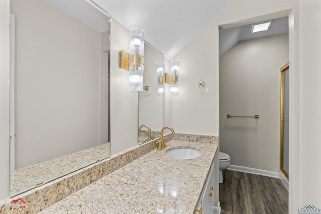 3408 Airline Rd, Longview, TX 75605 - full bath with wood finished floors, vaulted ceiling, vanity, and a shower with door