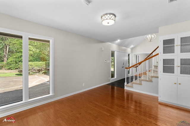 3408 Airline Rd, Longview, TX 75605 - foyer entrance with wood finished floors, stairway, lofted ceiling, and a chandelier