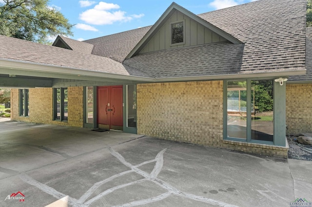 3408 Airline Rd, Longview, TX 75605 - entrance to property with board and batten siding, roof with shingles, and brick siding