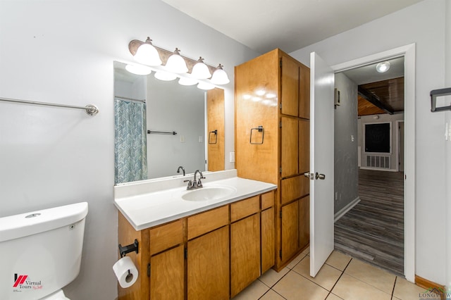 bathroom with tile patterned floors, toilet, and vanity