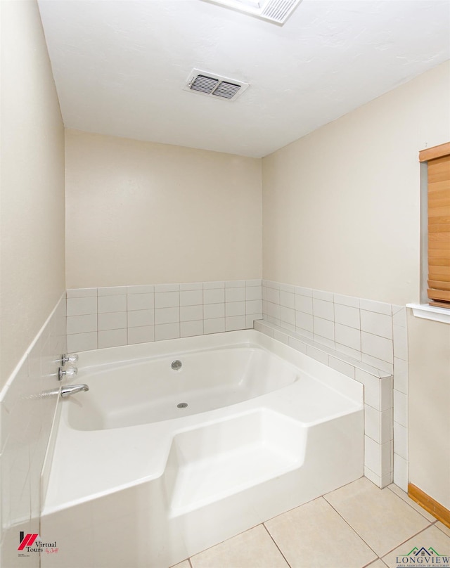 bathroom featuring a washtub and tile patterned flooring