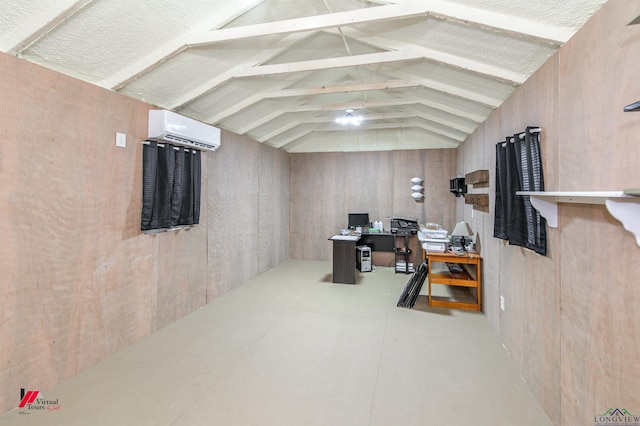 office space featuring a wall mounted AC and lofted ceiling