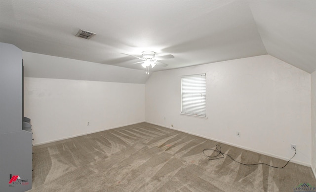 additional living space featuring ceiling fan, light carpet, and lofted ceiling