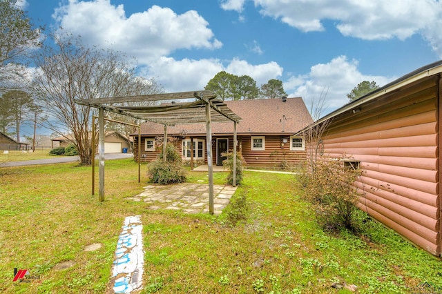 rear view of house featuring a yard, a pergola, and a patio area