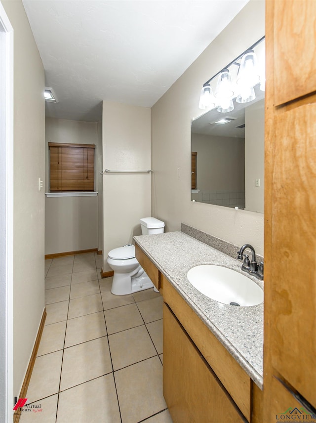 bathroom with tile patterned floors, vanity, and toilet