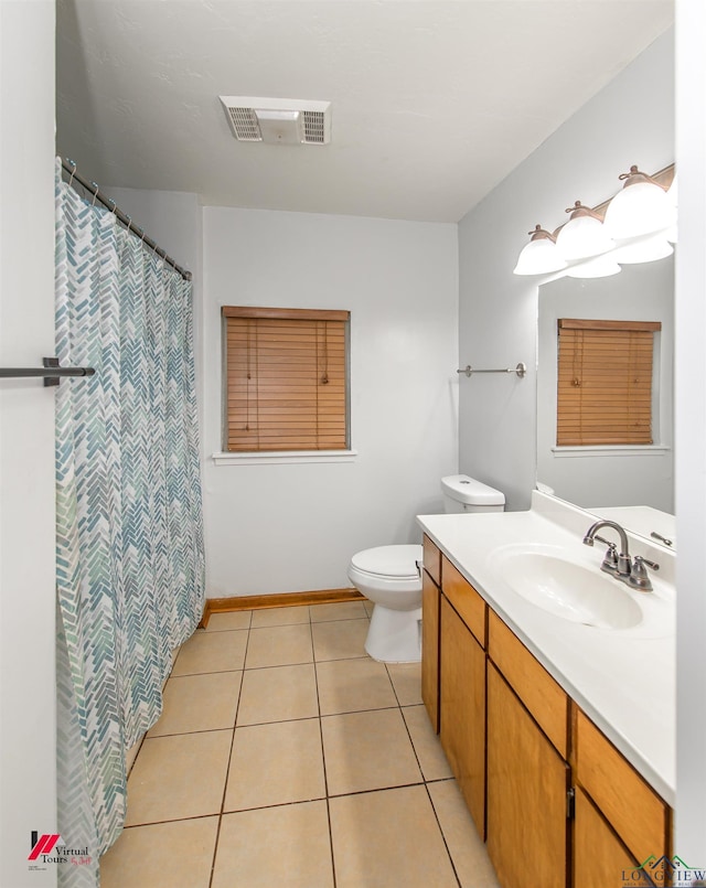 bathroom featuring vanity, toilet, and tile patterned floors