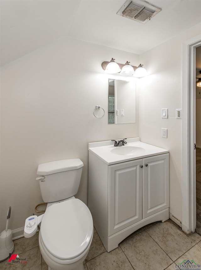 bathroom with toilet, tile patterned flooring, and vanity