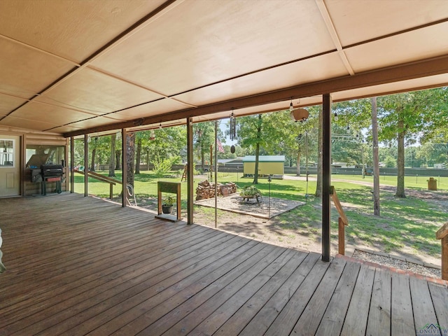 wooden terrace with a lawn