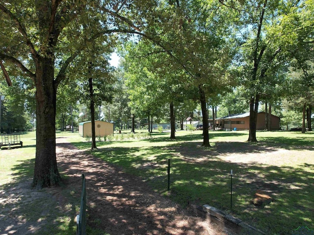 view of home's community with a shed and a yard