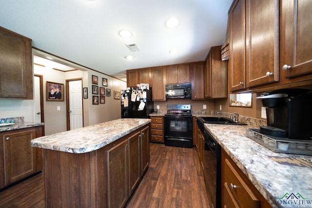 kitchen with a center island, dark wood-type flooring, black appliances, sink, and light stone countertops