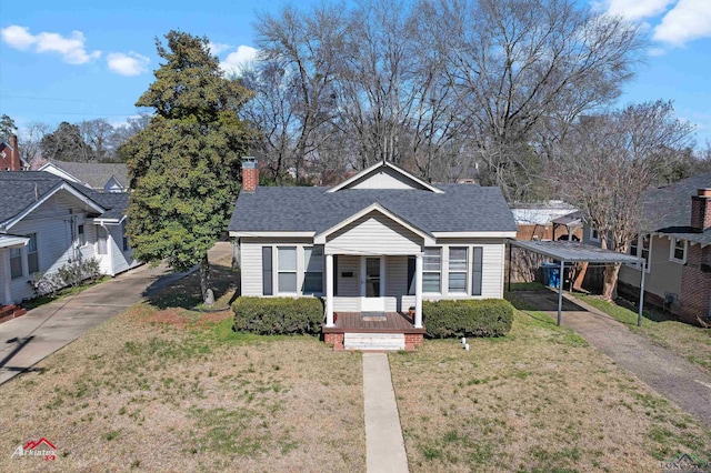 bungalow-style house featuring roof with shingles, a porch, a front lawn, and a chimney