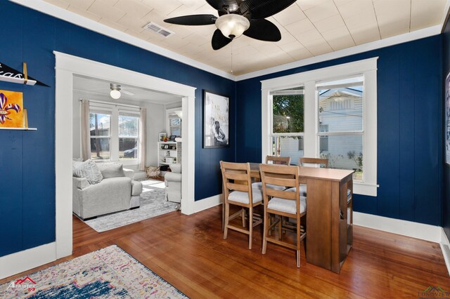 dining room featuring dark wood-style floors, ceiling fan, visible vents, and baseboards