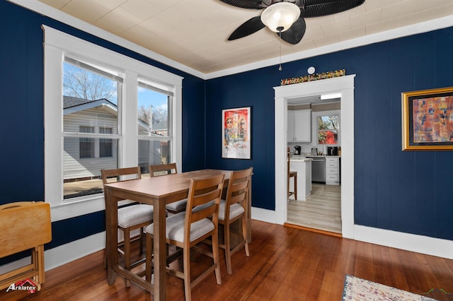 dining room featuring a ceiling fan, dark wood-style flooring, and plenty of natural light