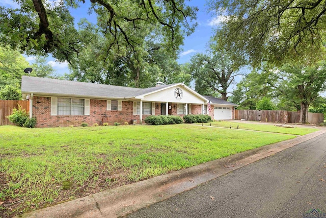 single story home with a front yard and a garage