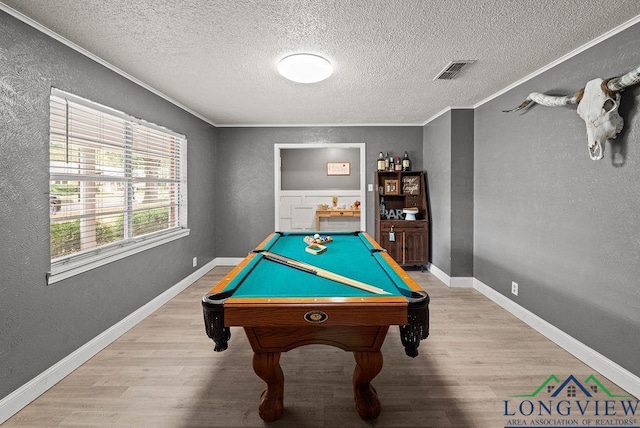 playroom featuring light hardwood / wood-style flooring, ornamental molding, a textured ceiling, and billiards