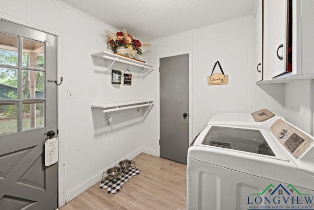 washroom with separate washer and dryer, crown molding, cabinets, and light hardwood / wood-style floors