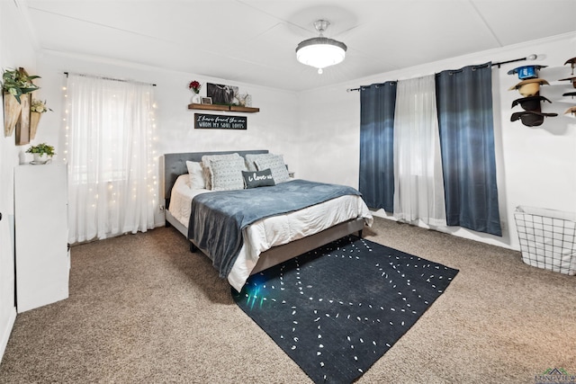 carpeted bedroom featuring crown molding