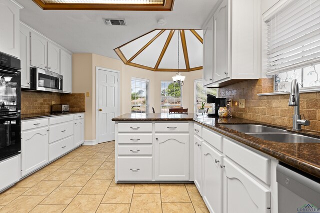504 Lakewood Dr, Longview, TX 75604 - kitchen with visible vents, dishwasher, a sink, a peninsula, and stainless steel microwave
