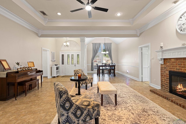 504 Lakewood Dr, Longview, TX 75604 - living area featuring visible vents, light tile patterned floors, ornamental molding, a fireplace, and ceiling fan with notable chandelier