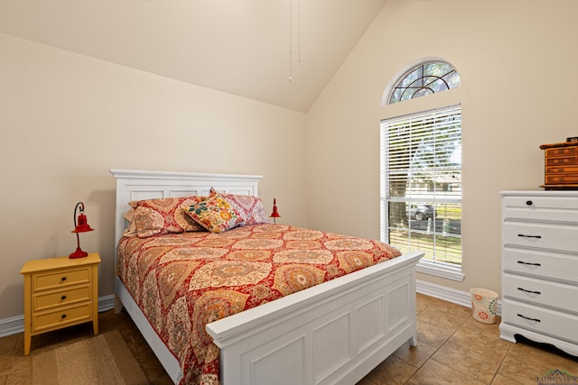 504 Lakewood Dr, Longview, TX 75604 - bedroom featuring high vaulted ceiling, light tile patterned floors, multiple windows, and baseboards