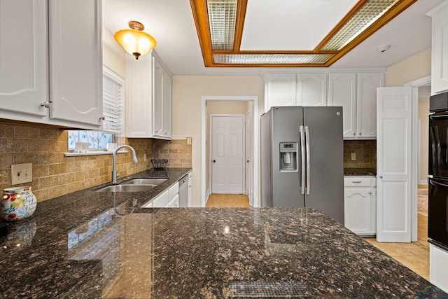 504 Lakewood Dr, Longview, TX 75604 - kitchen with tasteful backsplash, white cabinets, dark stone counters, appliances with stainless steel finishes, and a sink