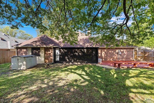 504 Lakewood Dr, Longview, TX 75604 - back of property with brick siding, a fenced backyard, a shingled roof, and a lawn