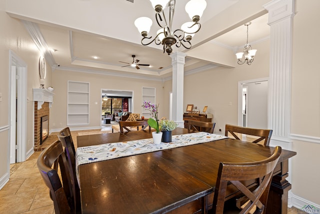 504 Lakewood Dr, Longview, TX 75604 - dining area with ceiling fan with notable chandelier, decorative columns, a fireplace, a tray ceiling, and ornamental molding