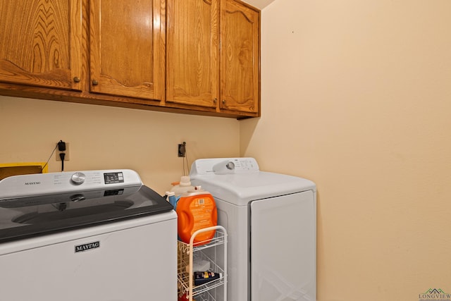 504 Lakewood Dr, Longview, TX 75604 - laundry area featuring washing machine and dryer and cabinet space