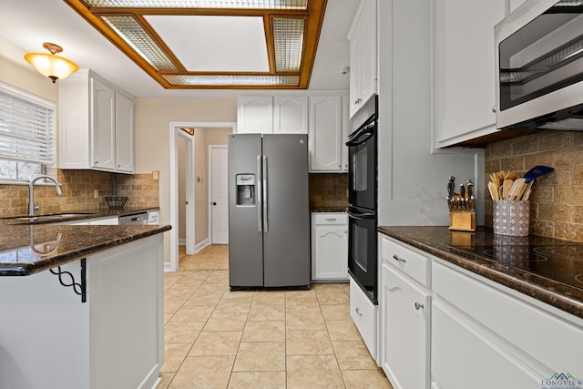 504 Lakewood Dr, Longview, TX 75604 - kitchen featuring a sink, backsplash, white cabinets, and black appliances