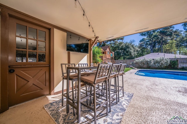 view of patio / terrace with a fenced in pool