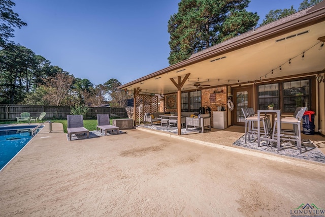 view of patio / terrace featuring a fenced in pool and ceiling fan