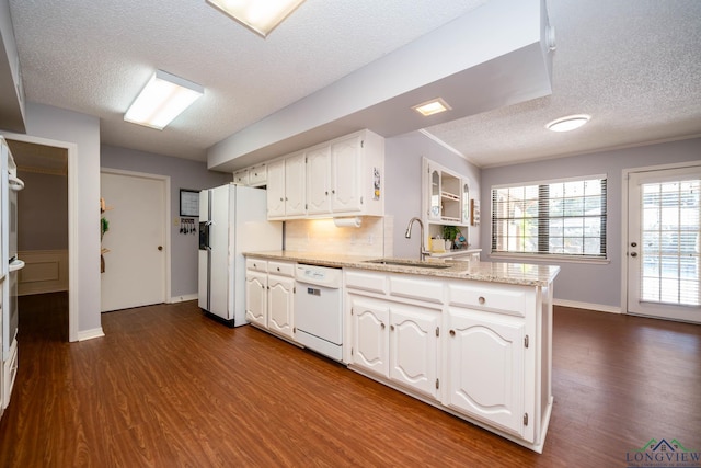 kitchen with white cabinetry, sink, dark hardwood / wood-style floors, and white appliances